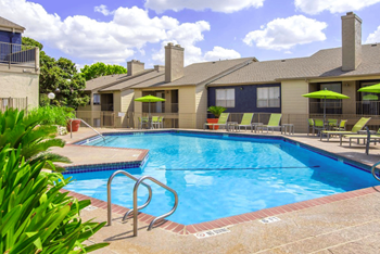 Swimming pool area with shaded chairs
